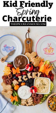 a platter filled with cookies, crackers and dips for kids to enjoy