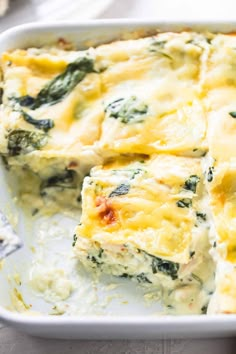 a casserole dish with spinach and cheese