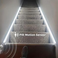 the stairs are lit up with white lights and there is a sign that says pir motion sensor