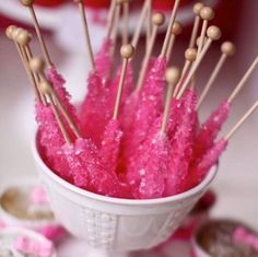 pink cake pops are in a white cup