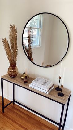 a mirror and some plants on a table