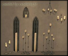 candles are lined up in front of a wall with stained glass windows and chandeliers