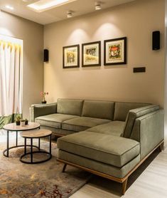 a living room filled with furniture and pictures on the wall