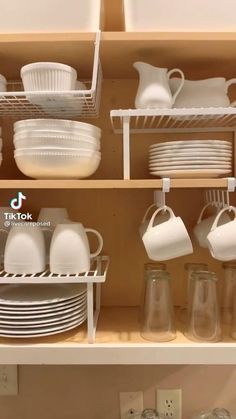 an open cabinet filled with dishes and glasses in the bottom shelf is labeled how to minimize your cabinet space