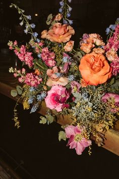 a vase filled with lots of flowers on top of a table