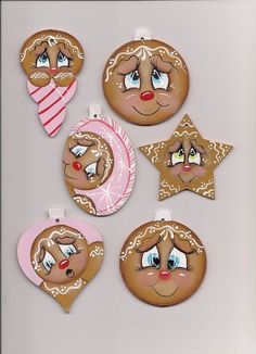 christmas ornaments made to look like gingerbreads with eyes, nose and mouth painted on them