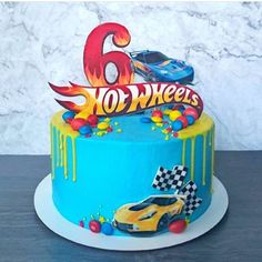 a birthday cake decorated with cars and the number six