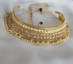 Check out this item in my Etsy shop https://www.etsy.com/listing/1256635982/gold-polki-choker-necklace-jhumka Gold Plated Choker For Wedding, Adjustable Gold Kundan Necklace Bollywood Style, Adjustable Round Kundan Necklace As Gift, Gold Hand Set Necklace For Navratri, Gold Necklace With Hand Set Stones For Navratri, Traditional Adjustable Kundan Necklace, Adjustable Traditional Kundan Necklace, Bollywood Style Gold Choker Necklace, Gold Choker For Wedding And Festive Occasions