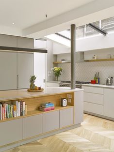 a kitchen with an island and bookshelf in it