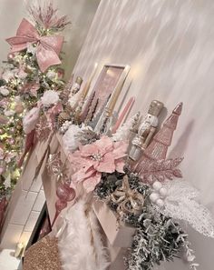 a decorated christmas tree in the corner of a room with pink and white decorations on it