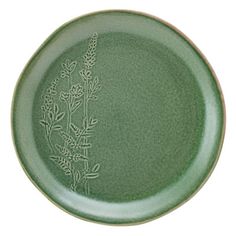 a green plate with a flower design on the front and side, against a white background