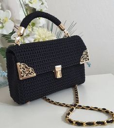 a black purse sitting on top of a white table