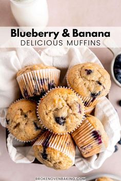 blueberry and banana delicious muffins in paper wrappers on a white plate