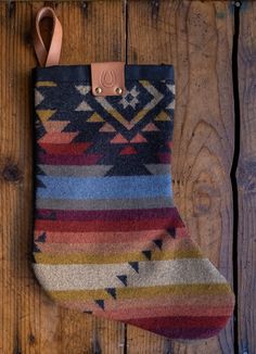 a colorful stocking hanging on a wooden wall