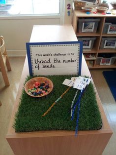 there is a sign that says, this week's challenge is to threadd the number of beads