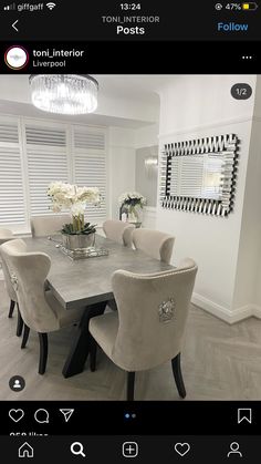 a dining room table with white chairs around it