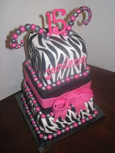 a birthday cake with zebra print and pink decorations