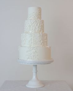 a white wedding cake sitting on top of a table