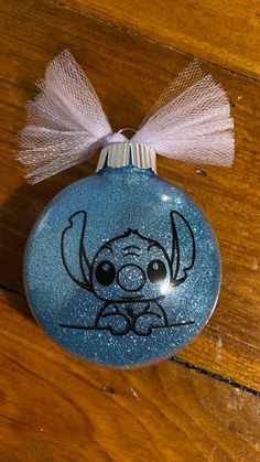 a blue ornament with a dog drawn on it