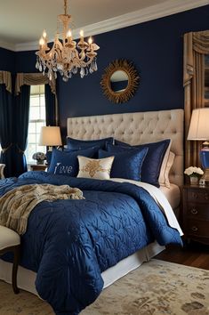 a bedroom with blue walls and white bedding, chandelier above the bed