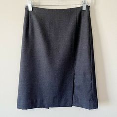 Falconnable wool pencil suit skirt in charcoal gray. Size 2. Knee length. Side zip closure. Lined. Slits at front and back. Pre-owned, excellent used condition. All measurements are approximate, not exact. Length: 21.5” Waist: 13.5” measured flat Professional Workwear, Charcoal Gray, Charcoal Grey, Side Zip, Knee Length, Work Wear, Size 2, Pencil, Wool