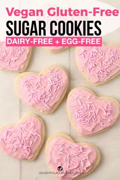 heart shaped sugar cookies with pink frosting and sprinkles in the shape of hearts