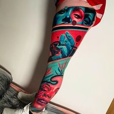 a woman's leg with colorful tattoos on it