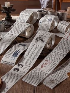 several rolls of paper sitting on top of a table next to some scissors and tape