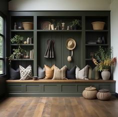 a room filled with lots of different types of pillows and hats on the wall next to a window