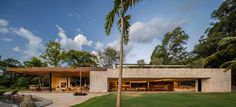 a house with a palm tree in front of it and a pool next to it