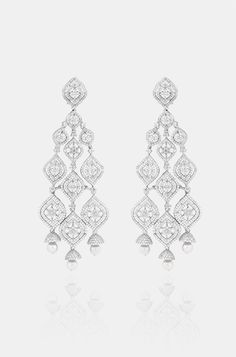 Introducing exquisite long Diamond dangler earrings, adorned with shimmering faux diamonds and graceful pearl drops, set against a pristine white finish. This statement piece exudes elegance and adds a touch of ravishing allure to any ensemble. Finish: Rhodium Material: Brass, Faux Diamonds, Pearls Color: White Size: One Size Closure Type: Push Back Box Contains: 1 Pair of Earrings Exquisite White Diamond Earrings For Evening, Luxury White Cubic Zirconia Linear Earrings, Luxury Earrings For Receptions, Luxury Earrings For Reception, Glamorous White Bridal Earrings With Elegant Design, White Pearl Drop Earrings For Reception, Silver Opulent Earrings For Evening, Elegant Pearl Drop Chandelier Earrings For Reception, Opulent Silver Earrings For Evening