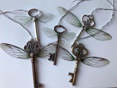 four antique keys with dragon wings attached to them