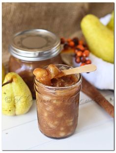 a jar filled with food sitting on top of a table next to bananas and other fruits