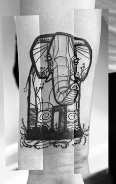 a black and white photo of an elephant tattoo