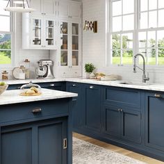 a kitchen with blue cabinets and white counter tops