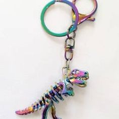 a keychain with a colorful lizard on it's side and a pair of scissors in the middle