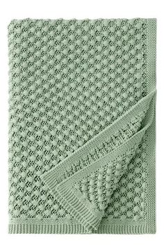 a green knitted blanket on a white background