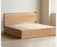 a bed with wooden headboard and foot board in a room next to a window