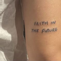 a person with a tattoo that says faith in the future