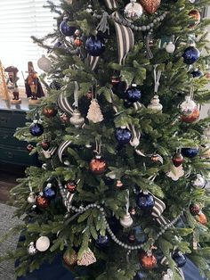 a christmas tree decorated with ornaments and ribbons