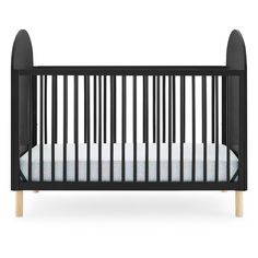 a black crib with white sheets and wood trims on the sides, in front of a white background