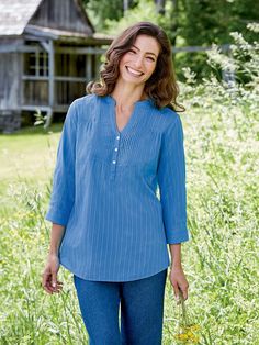 This casual top is cut to fit beautifully and comfortably and features delicate pintucking at the neckline for added polish and endless charm. Additional features include soft gathers at the shoulder, notched neckline with 3 buttons, and 3/4-sleeves with a button cuff that be rolled up and secured with a button tab. Split neckline with pintuck accentsSoft gathers at the shoulders3/4 cuffed sleeves with button tabsApprox. 29" long100% cottonMachine wash and dryImported Long Tunics For Women, Womens Plus Size Clothing, Tunic Sewing Patterns, Vermont Country Store, Notched Neckline, Linen Blend Pants, Cotton Tunic, Country Store, Women Tunic Tops