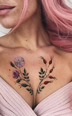 a woman with pink hair and tattoos on her chest