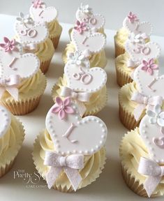 cupcakes decorated with white and pink decorations