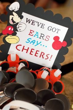 there is a sign that says we've got ears say cheers with mickey mouse on it