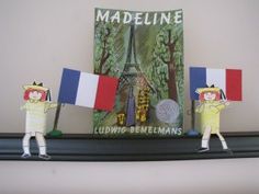 two figurines are holding flags in front of a book about the french flag