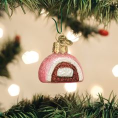 a pink ornament hanging from a christmas tree