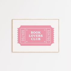 a pink book lover's club poster hanging on a wall