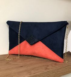 "Navy blue and coral sequin wedding clutch bag, handbag with removable chain, a very trendy accessory for your outings, a wedding, bridesmaids or a ceremony. The pouch will easily contain your essential phone, makeup, keys, glasses, papers ... It is made of suede with a very velvety touch, suede effect.  The tip of the flap is covered with navy blue glitter fabric.  2 options are possible: WITH or WITHOUT chain removable shoulder strap, gold or silver, you choose! This bag can be equipped with a shoulder strap chain. This one is very easily removable and your bag will become pocket! (length 120cm) It is lined in gold cotton perfectly matched. The very nice quality of the suede, which is also canvas, ensures a very good fit. The flap is closed by a golden or silver magnetic button according