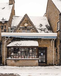 an old brick building with snow on the ground